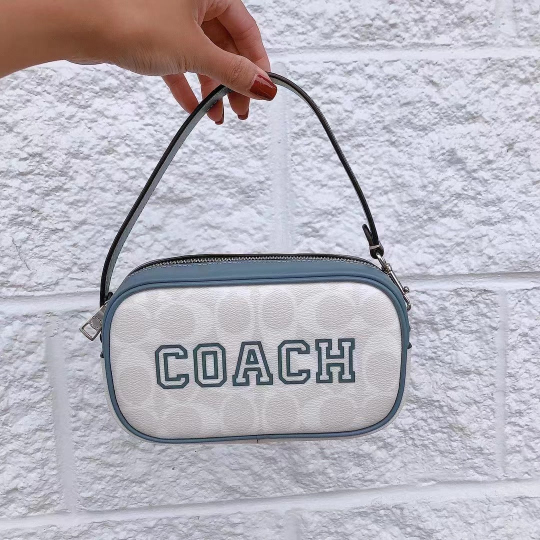 Coach CB851 Jamie Wristlet In Signature Canvas With Varsity Motif In SV/Chalk/Indigo Coach CB851 Jamie Wristlet In Signature Canvas With Varsity Motif In SV/Chalk/Indigo